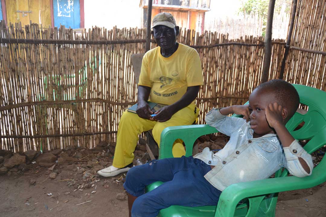 Gilbert Opio with his six year old son that just healed from measles. Credit: Dicta Asiimwe